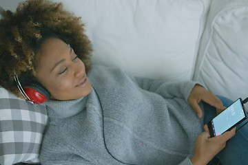 Image showing Content woman enjoying music