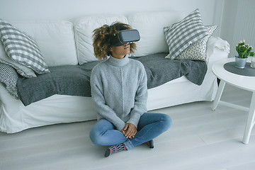 Image showing Woman in VR glasses at home