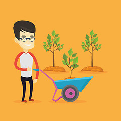 Image showing Man pushing wheelbarrow with plant.