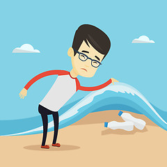 Image showing Man showing plastic bottles under sea wave.