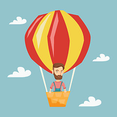 Image showing Young man flying in hot air balloon.