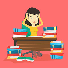 Image showing Student sitting at the table with piles of books.