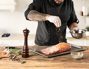 Image showing Man cooking meat steak on kitchen