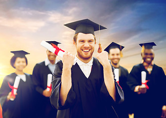 Image showing happy student with diploma celebrating graduation