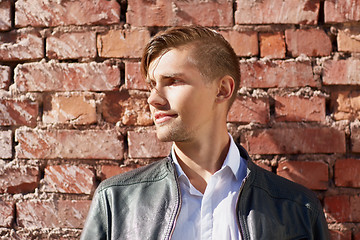 Image showing portrait of man in leather jacket over brick wall