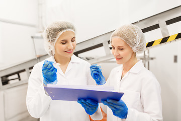 Image showing women technologists tasting ice cream at factory