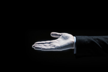 Image showing glowing businessman hand over black background