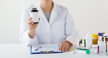 Image showing close up of doctor with medicines and clipboard