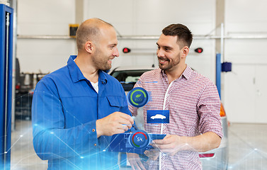 Image showing auto mechanic with clipboard and man at car shop