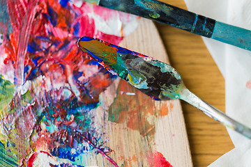 Image showing palette knife or painting spatula and paintbrush