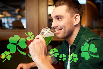 Image showing close up of man drinking green beer at bar or pub