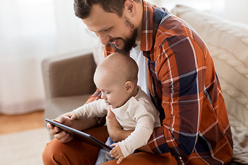 Image showing happy father and baby boy with tablet pc at home