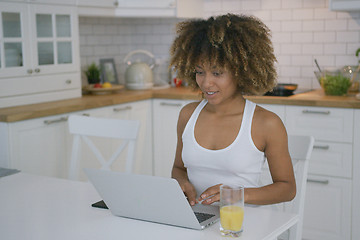 Image showing Charming model using laptop in kitchen