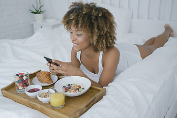 Image showing Pretty model having meal in bed