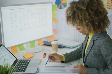 Image showing Young businesswoman working with documents