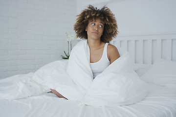 Image showing Upset woman cuddling in bed