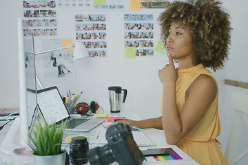 Image showing Stylish pensive worker at desktop