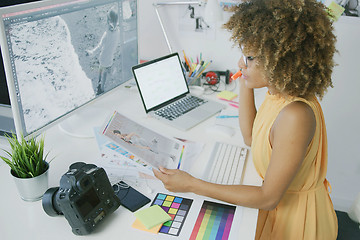 Image showing Pensive editor exploring photos