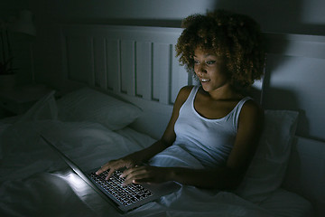 Image showing Young woman using laptop in night