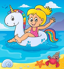 Image showing Girl floating on inflatable unicorn 2