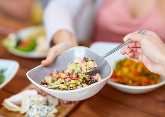 Image showing people eating salad at table with food