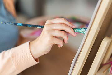 Image showing hand of artist with brush painting at art studio