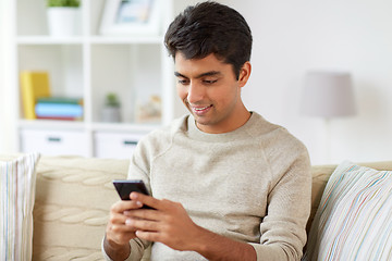 Image showing happy man with smartphone at home