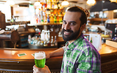 Image showing man drinking green beer at bar or pub