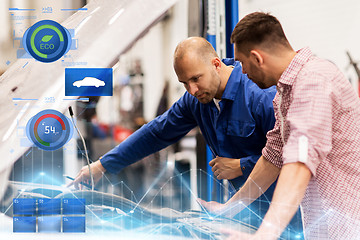 Image showing auto mechanic with clipboard and man at car shop