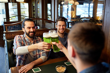 Image showing male friends drinking green beer at bar or pub