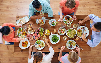 Image showing group of people eating at table with food