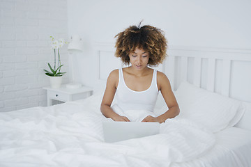 Image showing Charming woman with laptop in bed