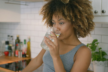 Image showing Woman drinking fresh water at home