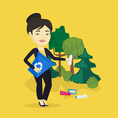 Image showing Woman collecting garbage in forest.