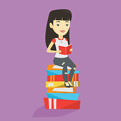 Image showing Student sitting on huge pile of books.