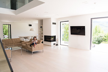 Image showing woman sitting on sofa with mobile phone