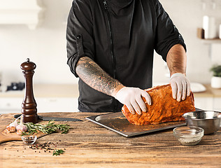 Image showing Man cooking meat steak on kitchen