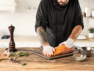 Image showing Man cooking meat steak on kitchen