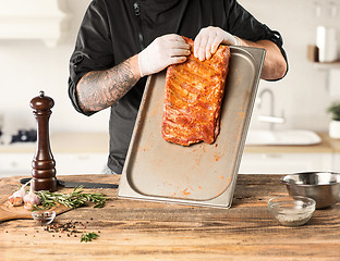 Image showing Man cooking meat steak on kitchen