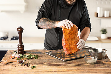 Image showing Man cooking meat steak on kitchen