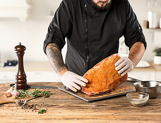 Image showing Man cooking meat steak on kitchen