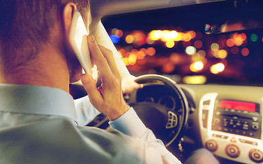 Image showing close up of man driving car calling on smartphone