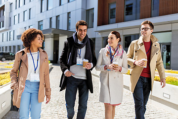 Image showing people with coffee and conference badges in city