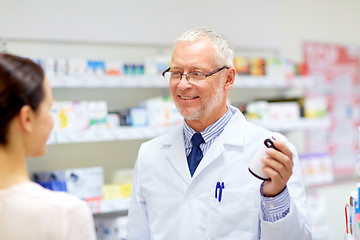 Image showing apothecary and woman with drug at pharmacy