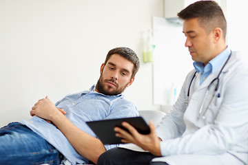 Image showing doctor and man with health problem at hospital