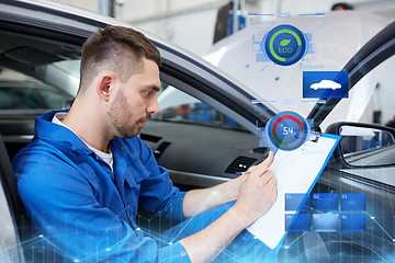 Image showing auto mechanic man with clipboard at car workshop