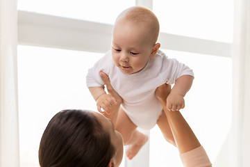 Image showing happy mother playing with little baby boy at home