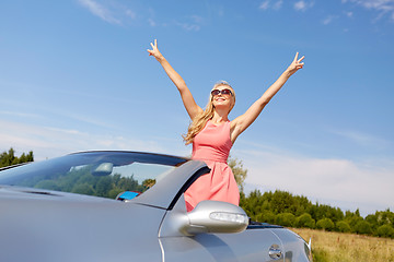 Image showing happy young woman in convertible car