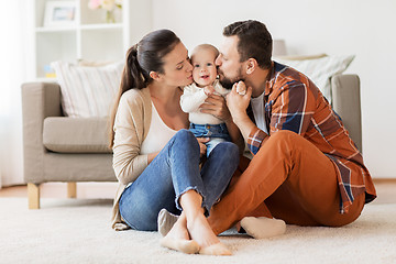 Image showing happy mother and father kissing baby at home