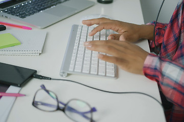 Image showing Crop worker typing on keyboard